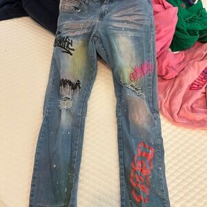 Stylish Distressed Blue Jeans with Colorful Accents